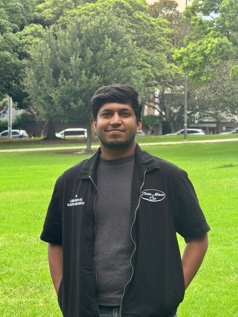 Abhishek Sebastian standing outdoors in a green park
